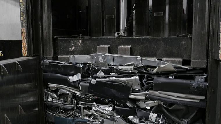Crushed material being pressed into a bale inside a baler