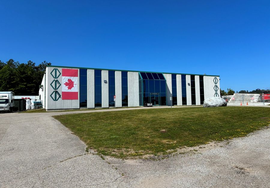 EDI's head office and processing facility in Orillia, with the Canadian flag on the front wall