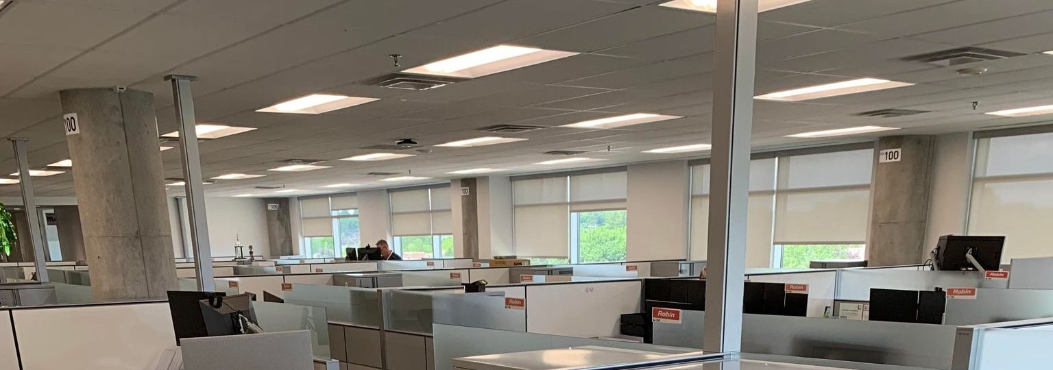 An open office floor of cubicles before a clear-out