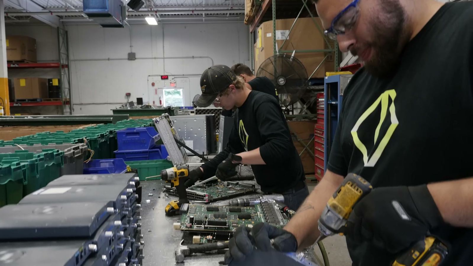 EDI technicians taking equipment apart at a workbench