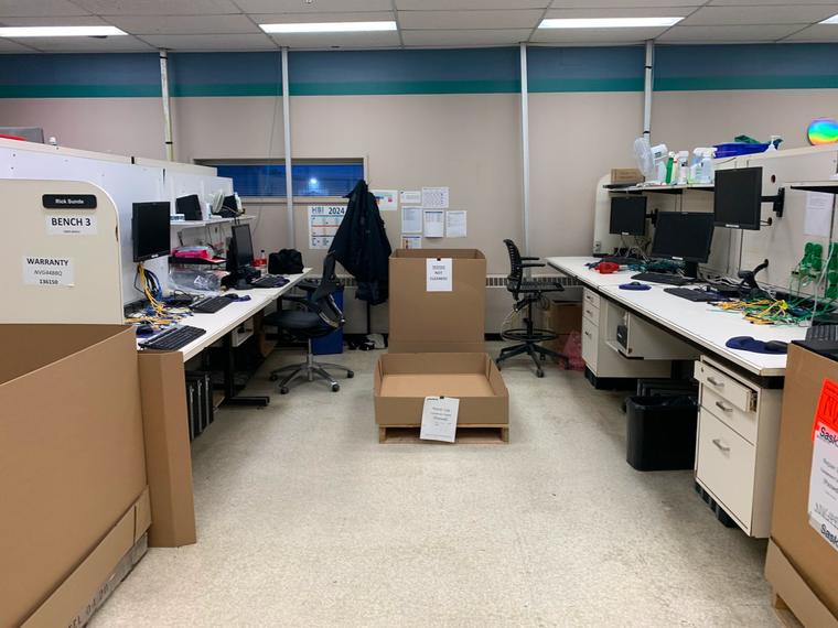 A working lab floor with benches, computers and shelving