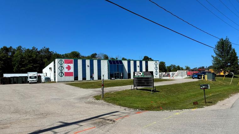 The EDI sign at the road, with the Orillia facility behind it