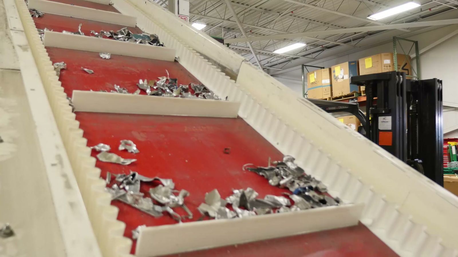 Shredded metal moving up a conveyor