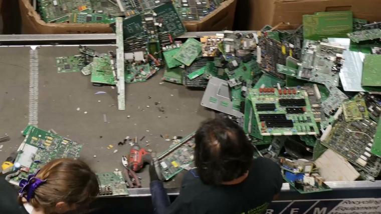 Circuit boards spread across the sorting line, seen from above