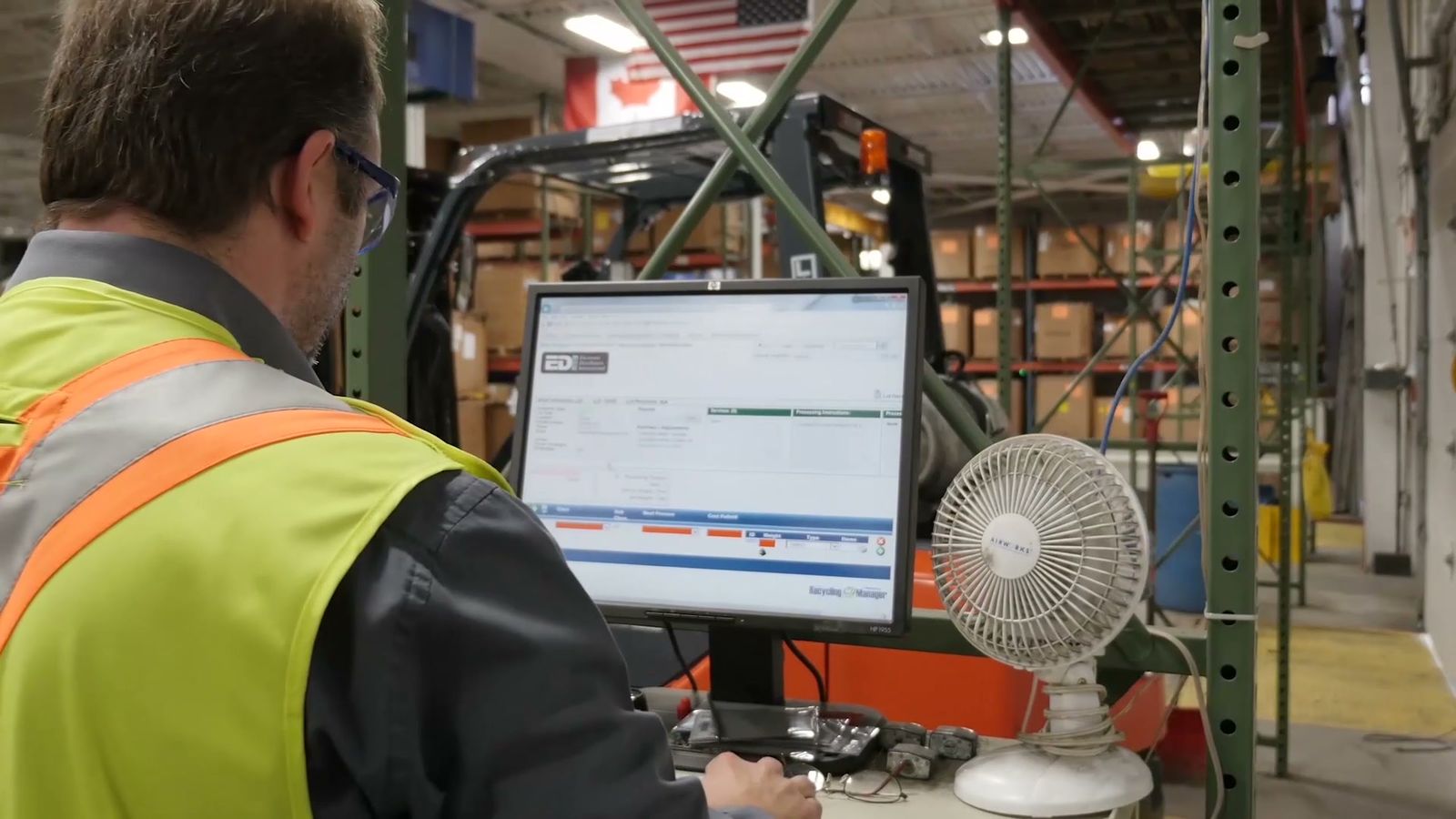 An EDI employee logging a load at the weigh station